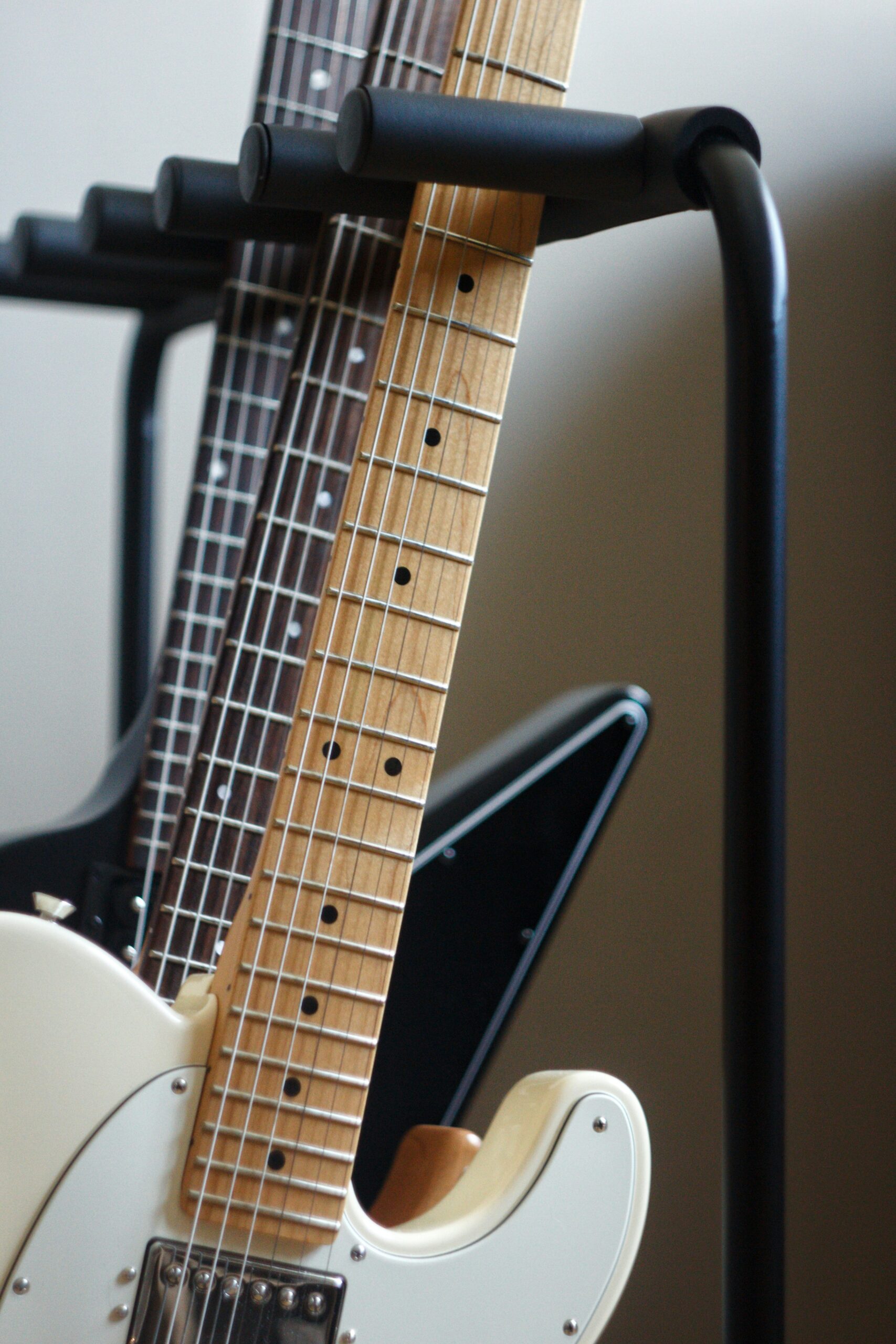 Several electric guitars on a rack