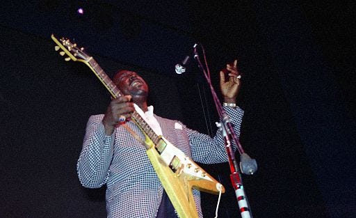 Albert King playing a Gibson Flying V guitar