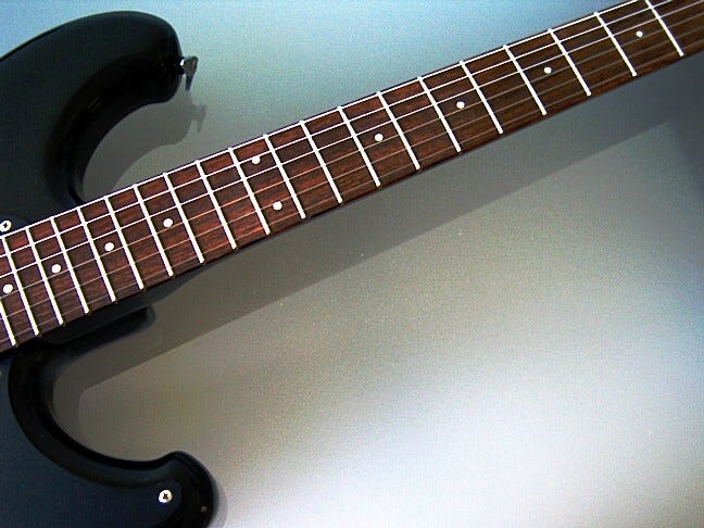 An electric guitar fretboard