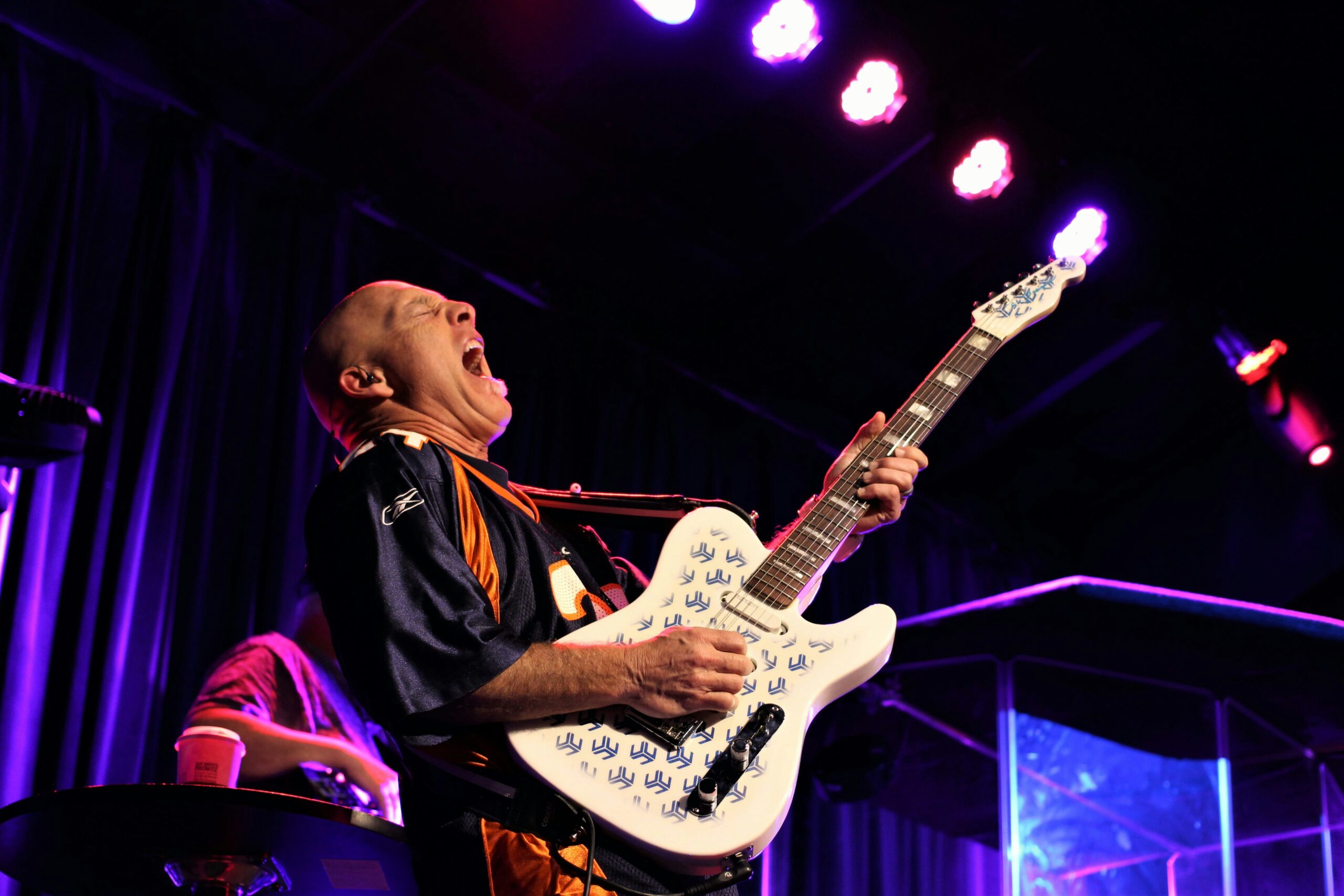 A man plays a Telecaster on stage